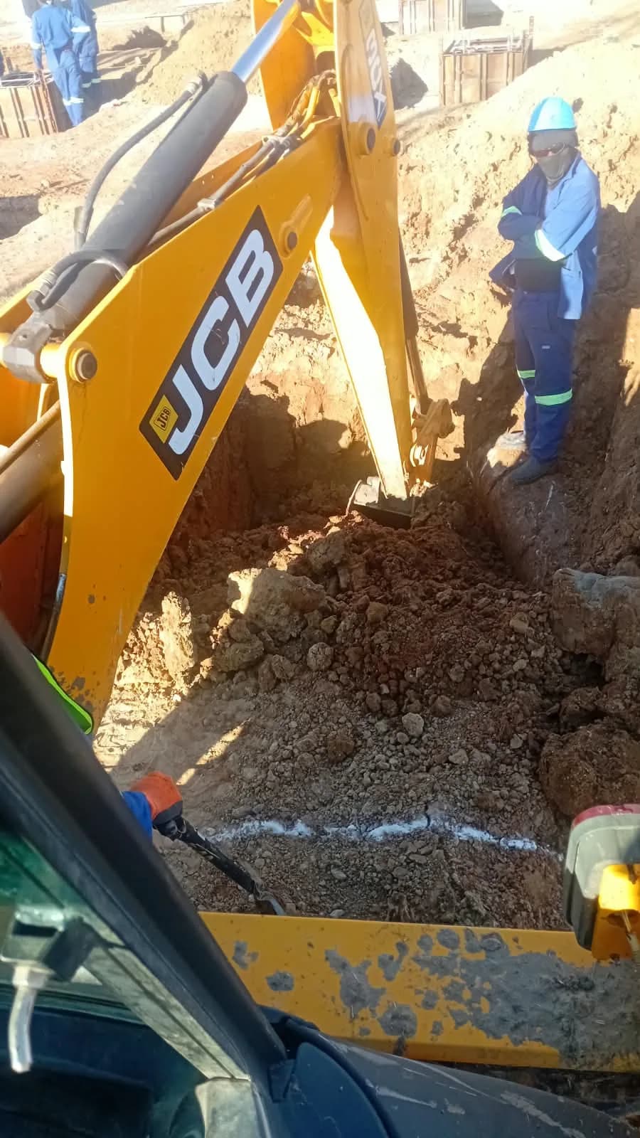 Backhoe excavating a trench by Seldariah Trading
